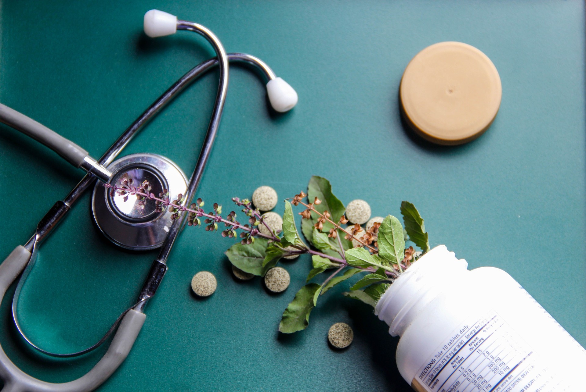 Medicinal herbs on green wooden board